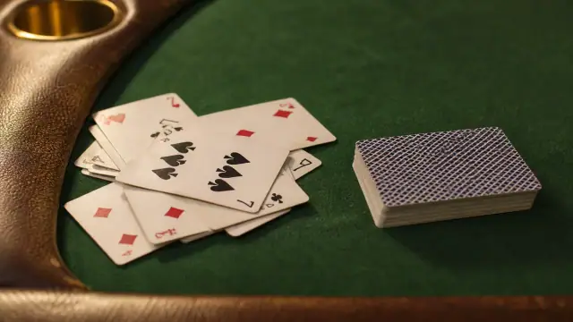 Open discard example with rummy hand notes and dark felt table markers